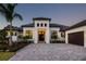 Modern home featuring a well-manicured front yard, a paver driveway, and neutral-toned stucco at 8563 Sea Mist Loop, Sarasota, FL 34240