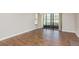 Bright living room with hardwood floors and sliding glass doors leading to a patio at 1151 Pine Ridge W Cir # H1, Tarpon Springs, FL 34688