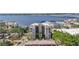 Amazing aerial view showcasing a building with a marina, water views, and lush green surroundings at 1400 1St W Ave # 203, Bradenton, FL 34205