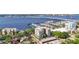 Attractive aerial view featuring a building with a marina, river views, and lush green surroundings at 1400 1St W Ave # 203, Bradenton, FL 34205