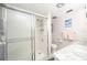 Bathroom featuring a glass enclosed shower, a marble vanity, and tile flooring at 1400 1St W Ave # 203, Bradenton, FL 34205