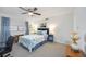 Bright bedroom with ceiling fan, white walls, and nautical-themed bedding at 1400 1St W Ave # 203, Bradenton, FL 34205