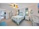 Bedroom featuring a closet, coastal themed decor, ceiling fan, and an ensuite bathroom at 1400 1St W Ave # 203, Bradenton, FL 34205