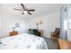 Bright bedroom with ceiling fan, white walls, and nautical-themed bedding at 1400 1St W Ave # 203, Bradenton, FL 34205