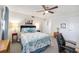 Bright bedroom with ceiling fan, white walls, and nautical-themed bedding at 1400 1St W Ave # 203, Bradenton, FL 34205