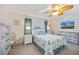 Bright bedroom with coastal themed decor, ceiling fan, and lots of natural light at 1400 1St W Ave # 203, Bradenton, FL 34205