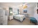 Comfortable bedroom featuring a ceiling fan, neutral color walls, carpet and beautiful decor at 1400 1St W Ave # 203, Bradenton, FL 34205