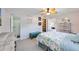 Bedroom featuring an ensuite bathroom with a glass enclosed shower, a closet and coastal themed decor at 1400 1St W Ave # 203, Bradenton, FL 34205