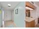 Inviting entryway featuring tile flooring, light blue walls, and a view of the kitchen bar area at 1400 1St W Ave # 203, Bradenton, FL 34205