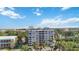 Condo building featuring multiple balconies and well-maintained landscaping at 1400 1St W Ave # 203, Bradenton, FL 34205