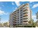 Condo building featuring multiple balconies and well-maintained landscaping at 1400 1St W Ave # 203, Bradenton, FL 34205
