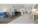 Bright hallway featuring tile floors, a piano, comfortable seating, and stylish decor at 1400 1St W Ave # 203, Bradenton, FL 34205