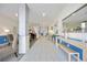 A hallway features tile floors, a piano, comfortable seating, and stylish decor at 1400 1St W Ave # 203, Bradenton, FL 34205