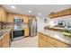 Modern kitchen with stainless steel appliances and oak cabinets at 1400 1St W Ave # 203, Bradenton, FL 34205