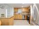 Bright kitchen with light wood cabinetry and stainless steel appliances at 1400 1St W Ave # 203, Bradenton, FL 34205