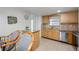 This kitchen features a breakfast bar with granite countertops, wood cabinets, stainless steel appliances and a window over the sink at 1400 1St W Ave # 203, Bradenton, FL 34205