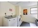 Bright laundry room with washer, dryer, and neutral color scheme at 1400 1St W Ave # 203, Bradenton, FL 34205