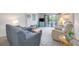 Comfortable living room with sliding glass doors to the balcony and neutral decor at 1400 1St W Ave # 203, Bradenton, FL 34205
