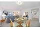 Cozy living space with a glass dining table, comfortable seating, and water views at 1400 1St W Ave # 203, Bradenton, FL 34205