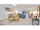 Open-concept living space with dining area, comfortable seating, and a view to the balcony at 1400 1St W Ave # 203, Bradenton, FL 34205