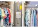 Walk-in closet showcasing organized clothing racks and a built-in water heater for space-saving functionality at 1400 1St W Ave # 203, Bradenton, FL 34205