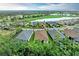 Wide aerial of house with a brown roof and a view of the community pond and golf course at 15605 Derna Ter, Bradenton, FL 34211