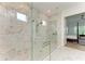 Luxurious bathroom with a glass shower, marble tile, and high-end finishes at 15605 Derna Ter, Bradenton, FL 34211