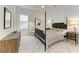 Well-lit bedroom with a four-poster bed, neutral decor, and soft carpet at 15605 Derna Ter, Bradenton, FL 34211