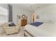 Bright bedroom featuring a cozy armchair, wood cabinet, and plush carpet at 15605 Derna Ter, Bradenton, FL 34211