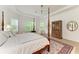 Bright bedroom featuring a four-poster bed and hardwood floors at 15605 Derna Ter, Bradenton, FL 34211
