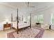 Spacious bedroom features tray ceiling, hardwood floors, large windows, and elegant decor at 15605 Derna Ter, Bradenton, FL 34211