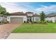 Charming single-story home with a well-manicured lawn, beautiful landscaping, and a brick driveway at 15605 Derna Ter, Bradenton, FL 34211