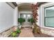 Charming front entrance featuring double doors, a brick walkway, and manicured landscaping at 15605 Derna Ter, Bradenton, FL 34211