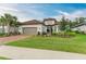 Charming single-story home featuring a tile roof, a brick driveway, and beautiful landscaping at 15605 Derna Ter, Bradenton, FL 34211