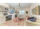 Bright home office featuring built-in storage, a ceiling fan, and comfortable seating at 15605 Derna Ter, Bradenton, FL 34211
