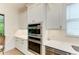 Kitchen area featuring stainless steel appliances, white cabinets and tile backsplash at 15605 Derna Ter, Bradenton, FL 34211