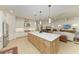 Open concept kitchen featuring a large island, stainless appliances, and natural lighting at 15605 Derna Ter, Bradenton, FL 34211