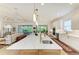 Open-concept kitchen with a large island, modern appliances, and backyard access at 15605 Derna Ter, Bradenton, FL 34211