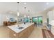 Bright kitchen with white cabinets, stainless steel appliances, and a large center island with seating at 15605 Derna Ter, Bradenton, FL 34211