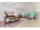 Open-concept living room with dining area, hardwood floors, natural light, and backyard view at 15605 Derna Ter, Bradenton, FL 34211