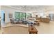 Open-concept living room with hardwood floors, lots of natural light, and access to the kitchen at 15605 Derna Ter, Bradenton, FL 34211