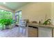 Covered outdoor kitchen with built-in grill, sink, mini fridge and beautiful landscaping at 15605 Derna Ter, Bradenton, FL 34211