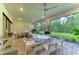 Relaxing screened-in patio featuring tile floors, ceiling fans and outdoor furniture at 15605 Derna Ter, Bradenton, FL 34211