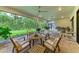 Large screened-in patio with outdoor dining area and kitchen offers relaxing entertainment space at 15605 Derna Ter, Bradenton, FL 34211