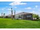 Manicured lawn with palm trees and a screened in lanai at 16234 Isola Pl, Bradenton, FL 34211