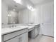 Stylish bathroom featuring double vanity sinks, a large mirror, and a walk-in shower at 16234 Isola Pl, Bradenton, FL 34211