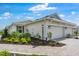 Exterior view of home with landscaped yard, 2 car garage, and walkway at 16234 Isola Pl, Bradenton, FL 34211