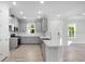 Bright kitchen featuring gray cabinets, stainless appliances, and a quartz countertop island at 16234 Isola Pl, Bradenton, FL 34211
