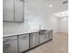 Kitchen with stainless steel appliances, gray cabinets, and quartz countertops at 16234 Isola Pl, Bradenton, FL 34211