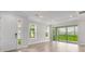 Bright living room featuring tile floors, recessed lighting, and sliding glass doors to the backyard at 16234 Isola Pl, Bradenton, FL 34211